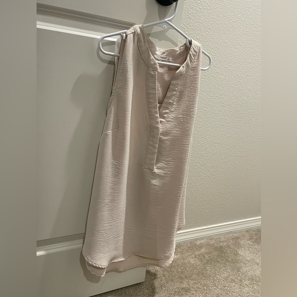 Tan sleeveless blouse. Loose fitting. Excellent condition. Size small.